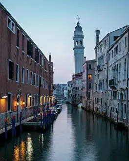 Romance Prints: Quiet waters reflect buildings at dusk along a canal in Venice