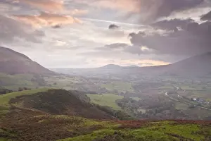 Keswick Prints: Rain clouds battle with the sunrise over the Lake District near to Keswick
