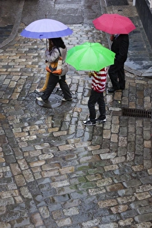 Umbrellas Prints: Rain on cobbled street, Seville, Andalucia, Spain, Europe