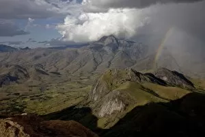 A rainbow appears looking east across the granite mountains of the Andringitra National Park