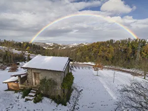 Rainbow arch above a small cottage and a snowy winter countryside landscape, Emilia Romagna, Italy, Europe Rainbow arch above a small cottage and a snowy winter countryside landscape, Emilia Romagna, Italy, Europe