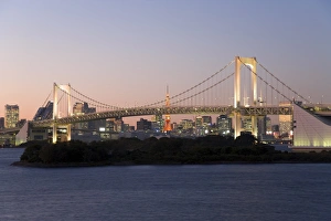 Rainbow Bridge and Tokyo Tower illuminated at dusk