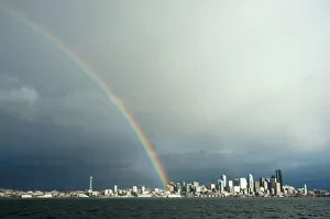 Images Dated 30th December 2011: A rainbow lands on a Washington State Ferry in the Puget Sound with the Seattle skyline in