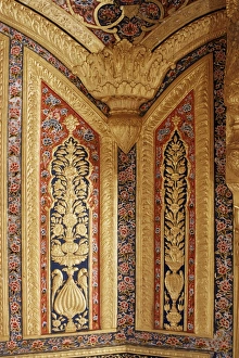 Raised gilded plaster work on painted wall
