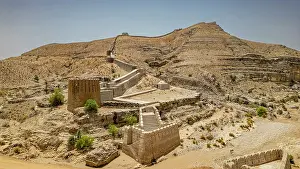 Fortifications Prints: Ranikot fort stands on a rugged landscape under bright sunlight in Sindh