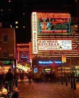 Night Life Collection: The Raymond Revuebar with neon signs in red light area at night, Soho, London
