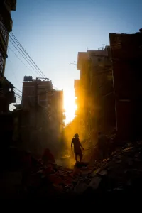 Natural Disaster Prints: Rays of early evening sun on the dusty streets of Thamel after earthquake, Kathmandu