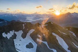 Sunbeam Prints: Last rays of sunset light the rocky mountain peaks, Furka Pass, Canton Uri, Switzerland