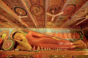 Meditation Prints: A reclining Buddha statue shows intricate details and designs within Isurumuniya Rajamaha Viharaya temple