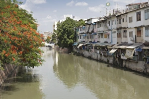 Flats Prints: Red blossom and flats along a canal in Banglamphu, Bangkok, Thailand, Southeast Asia, Asia