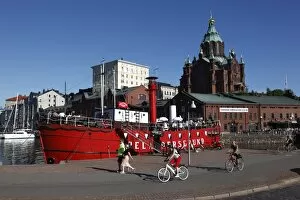 Red boat and restaurant at North Harbour, with Uspenski Cathedral in the background