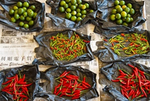 Red chilli peppers and limes, food market, Kuching, Sarawak, Malaysian Borneo, Malaysia, Southeast Asia, Asia