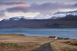 Images Dated 18th October 2008: Red-roofed house and snow-capped mountains in Reydarfjordur fjord, East Fjords