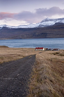 Images Dated 18th October 2008: Red-roofed house and snow-capped mountains in Reydarfjordur fjord, East Fjords