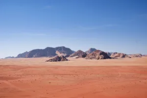 Wadi Rum Prints: Red sand and mountains under a blue sky in the Wadi Rum desert, Jordan, Middle East