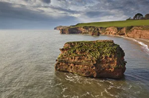 Red sandstone cliffs and rocks at Ladram Bay, in the Jurassic Coast UNESCO World Heritage