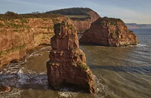 Red sandstone cliffs and rocks at Ladram Bay, in the Jurassic Coast UNESCO World Heritage