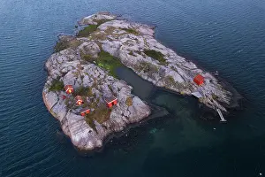 Sweden Prints: Red traditional boat houses and cottages on a rocky island surrounded by the ocean