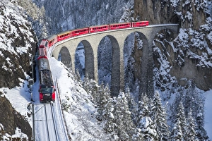 The red train of the Albula-Bernina Express Railway, UNESCO World Heritage on the Landwasser Viaduct, Switzerland, Europe