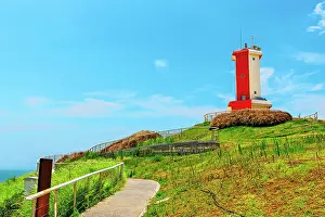 Navigation Prints: Red and white lighthouse stands on a hill above the sea in Little Weihai