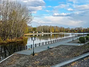 Lamp Prints: Reflecting water with trees and walkway in Kyzyl National Park in Republic of Tuva in Russia during autumn season