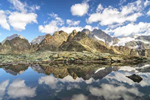 Rugged Terrain Prints: Reflection in Alpine lake in Valmalenco