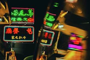 Lively Prints: A reflection of Neon Signs at night in Mong Kok in Kowloon, Hong Kong, China