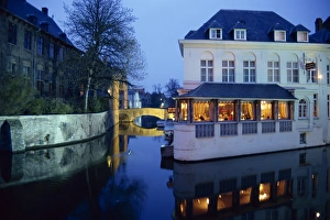 Bruge Prints: Reflections in the canals of restaurant and bridge, illuminated in the evening