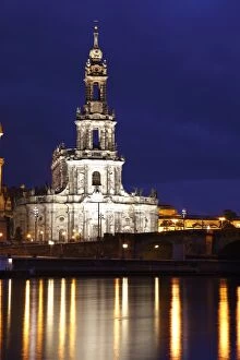 Reflections in the Elbe River of lights at night and the Catholic Hofkirche