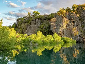 Madagascar Prints: Reflections of mangroves along a brackish lagoon in Madagascar during sunrise near water's edge