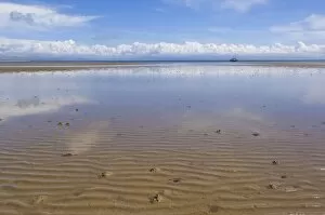 Reflections in the tidal seawater pools of the long sweeping beach of Llanbedrog