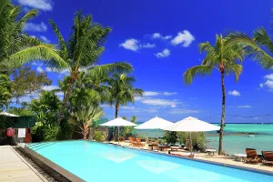 Chairs Prints: Relaxing by the pool at a resort in Mauritius with palm trees and clear skies