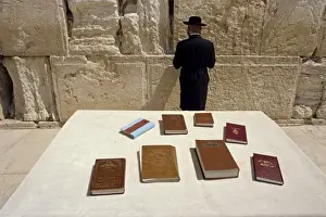 Western Wall Prints: Religious books on table and Jewish man facing the Western Wall