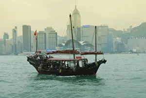 One of the last remaining Chinese junk boats sails on Victoria Harbour