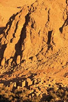 High Atlas Prints: Remains of the kasbah at foot of towering cliffs at sunrise