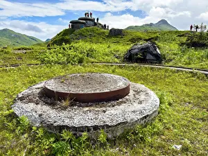 Relics Prints: Remains of World War II gun emplacement in Unalaska area with visitors exploring historical site