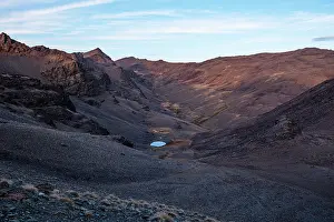 Glacial Prints: Remote alpine glacial lake in Wast Valley below Cerro del Caballo in Sierra Nevada National Park in Andalusia