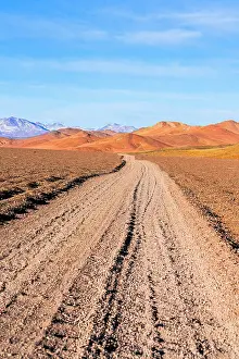 Dirt Prints: Remote dirt road in the red earth landscape, Puna, Argentina