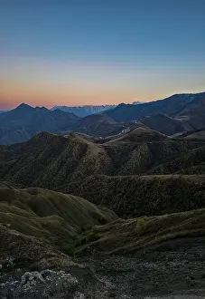 Trail Prints: Remote mountain landscape shows peaks and valleys in Chechnya during dusk