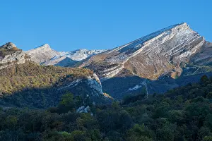 Trail Prints: Remote mountain scenery in the Caucasus region of Russia with clear skies and snow-capped peaks