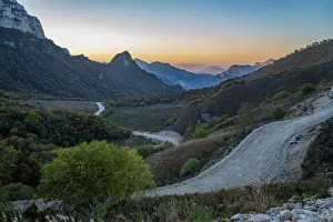 Terrain Prints: Remote mountain scenery shows winding roads and hills during sunset in Chechnya