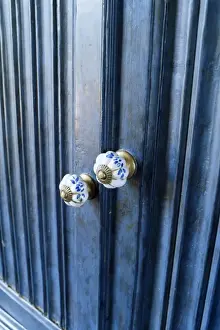 Detail of reproduction hand painted china cupboard door knobs in a home