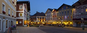 Upper Austria Prints: Restaurants in Market Square illuminated at dusk