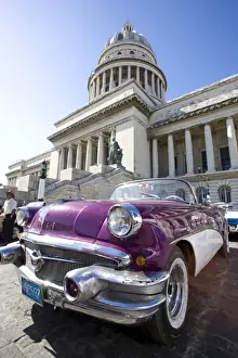Civic Prints: Restored classic American car parked outside The Capitilio, Havana, Cuba