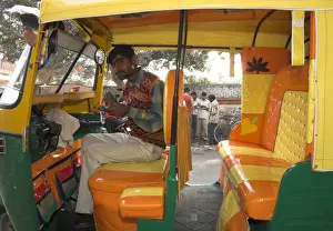 Small Business Prints: Rickshaw owner sitting in his newly decorated moto rickshaw