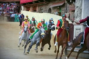 Images Dated 16th August 2010: Riders racing at El Palio horse race festival, Piazza del Campo, Siena