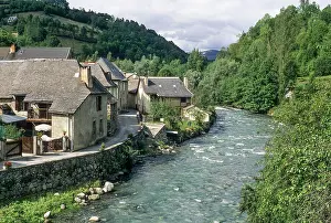 Surroundings Prints: River flows past homes in Bordes-sur-Lez, a village in the Couserans region of France