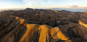Empty road crossing the barren mountains of Pajara at dawn from Sicasumbre observatory