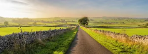 Trail Prints: Road through fields leading to Monyash in autumn near Bakewell in Derbyshire Peak District