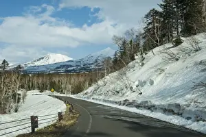 Hokkaido Prints: Road leading through the snow capped mountains of the Daisetsuzan National Park